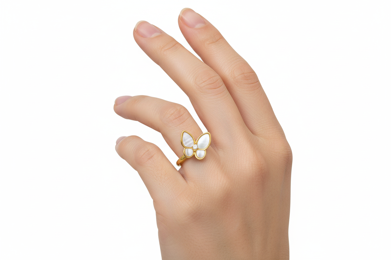 A gold-plated open ring with a pearl and a butterfly design with white and blue enamel wings.