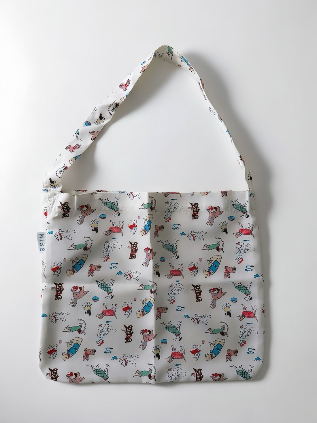 Patterned tote bag with cartoon characters on a white background