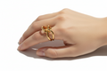 Hand wearing a gold ring on a white background