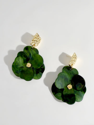 Green floral earrings with gold accents on a light gray background